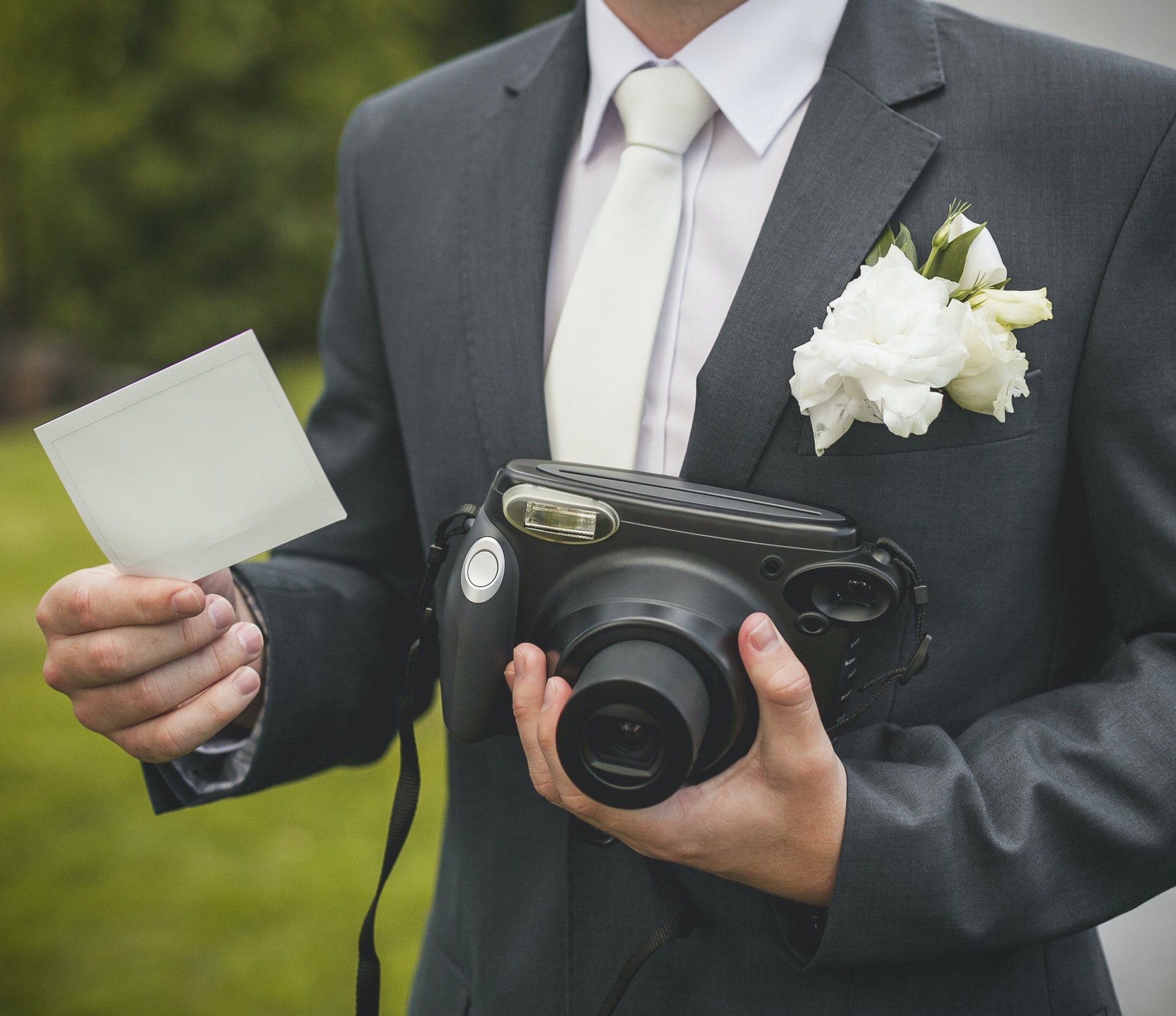 part-of-groom-with-retro-camera-and-empty-card.jpg