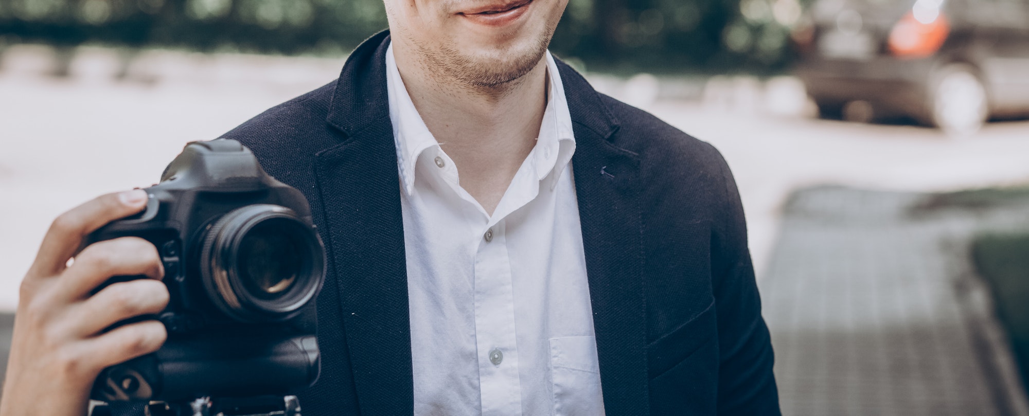 stylish-man-holding-photo-camera.jpg